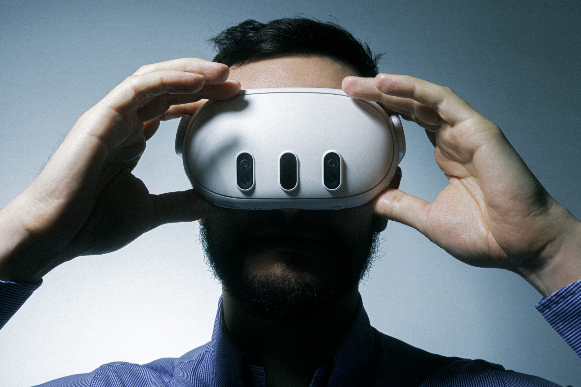 A person adjusting a mixed-reality headset