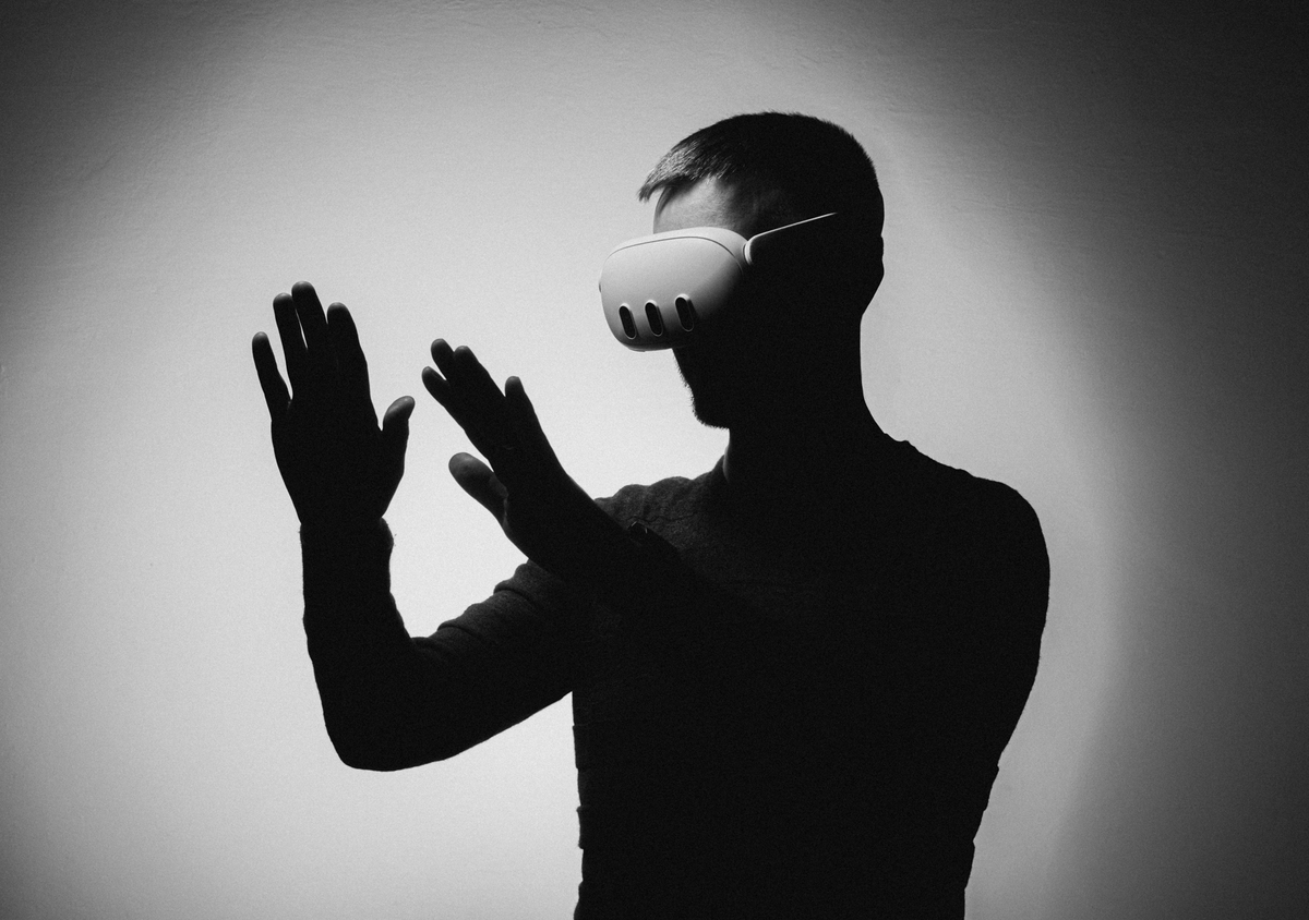 A person using hand gestures while wearing a mixed-reality headset
